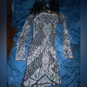 Black Party dress covered in rhinestones and stops at about knee length.